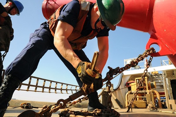 Construction worker tightening a bolt.