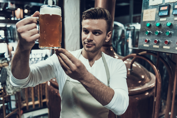 Craft brewer viewing a sample of beer.