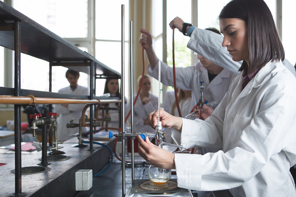 Group of technicians working with chemicals.