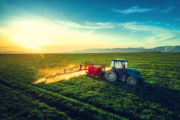 Tractor treating crops.