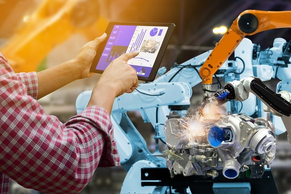 Worker using a tablet to check product compliance.